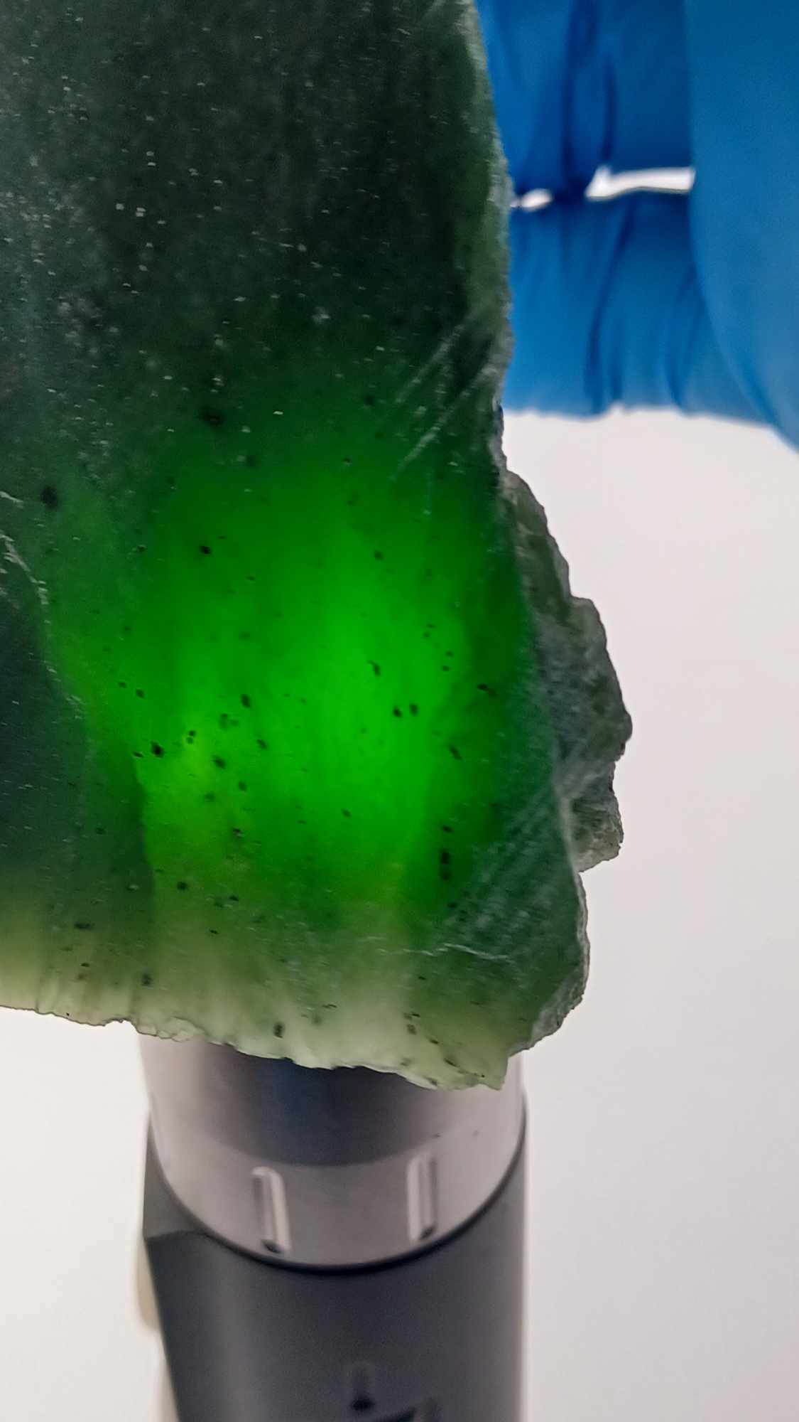 High-resolution image of a Grade-B Cassiar nephrite Jade Triangle cut 367g showcasing its luminous, translucent green jade with intricate Colors of Light Transparent Green, from British Columbia Canada