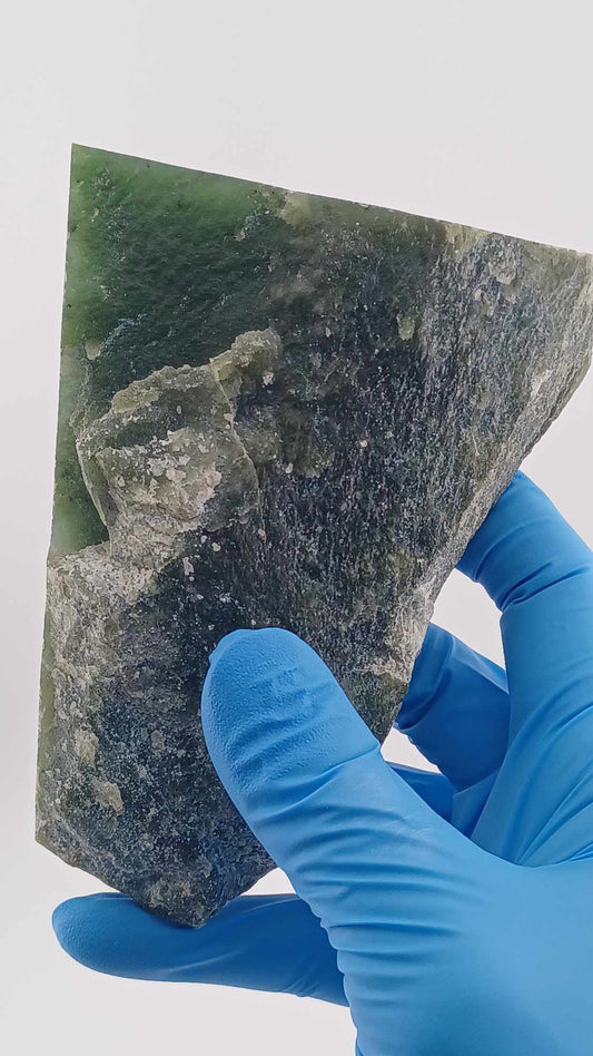 High-resolution image of a Cassiar Nephrite Jade Slab High Translucency 547g showcasing its luminous, translucent green jade with intricate Colors of Light Transparent Green