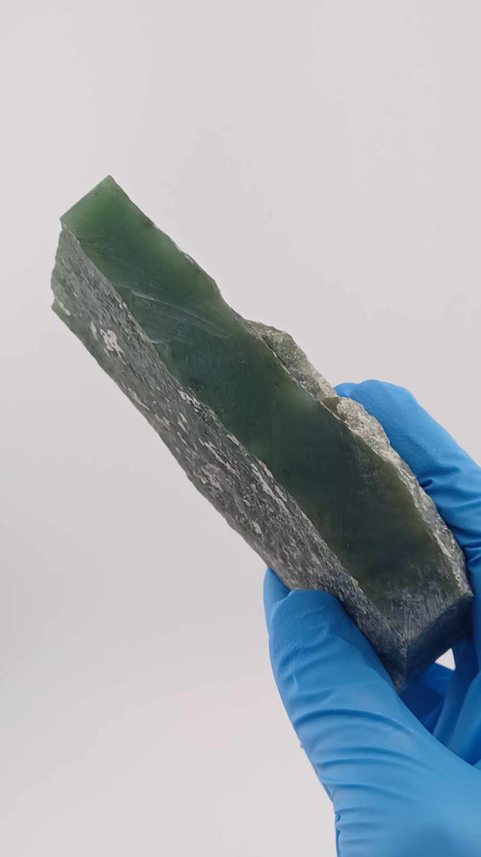 side view of High-resolution image of a Cassiar Nephrite Jade Slab High Translucency 547g showcasing its luminous, translucent green jade with intricate Colors of Light Transparent Green