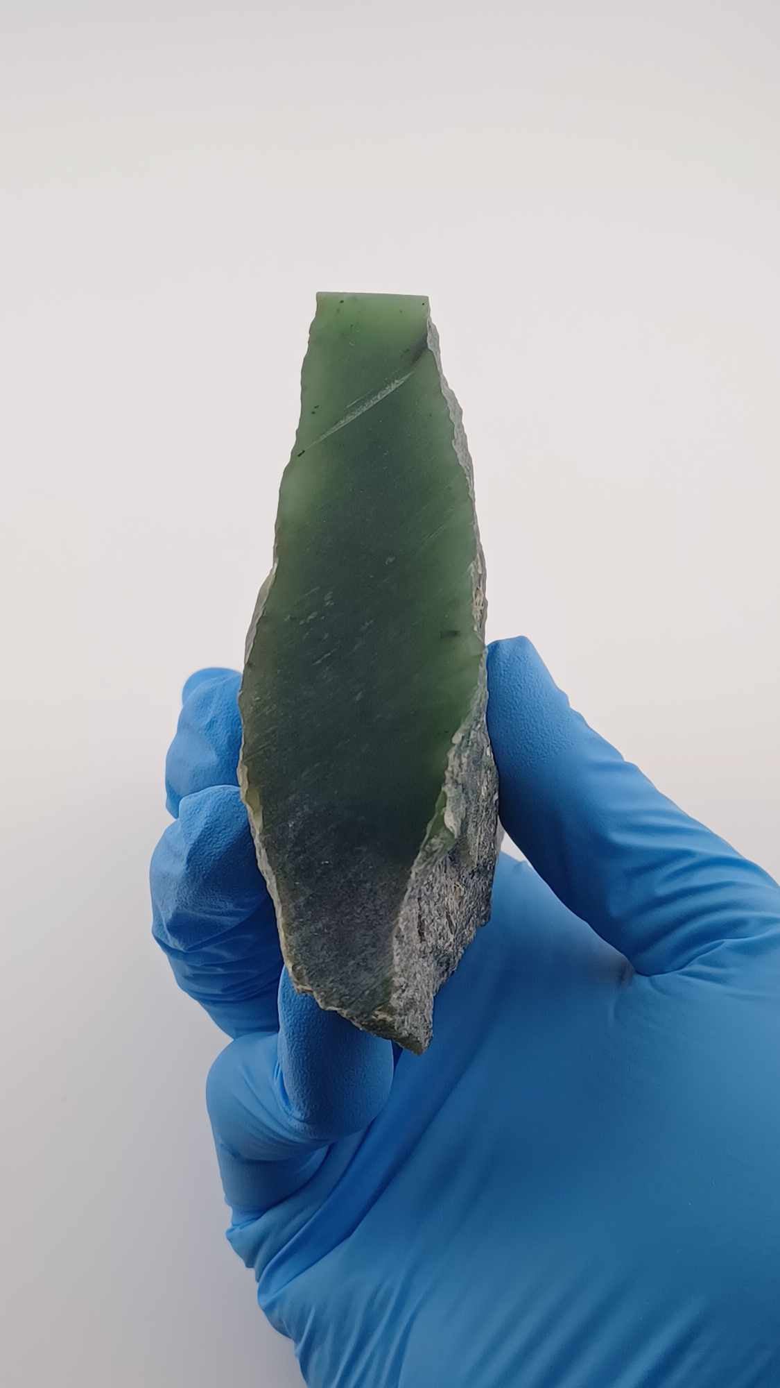 front view of High-resolution image of a Cassiar Nephrite Jade Slab High Translucency 547g showcasing its luminous, translucent green jade with intricate Colors of Light Transparent Green