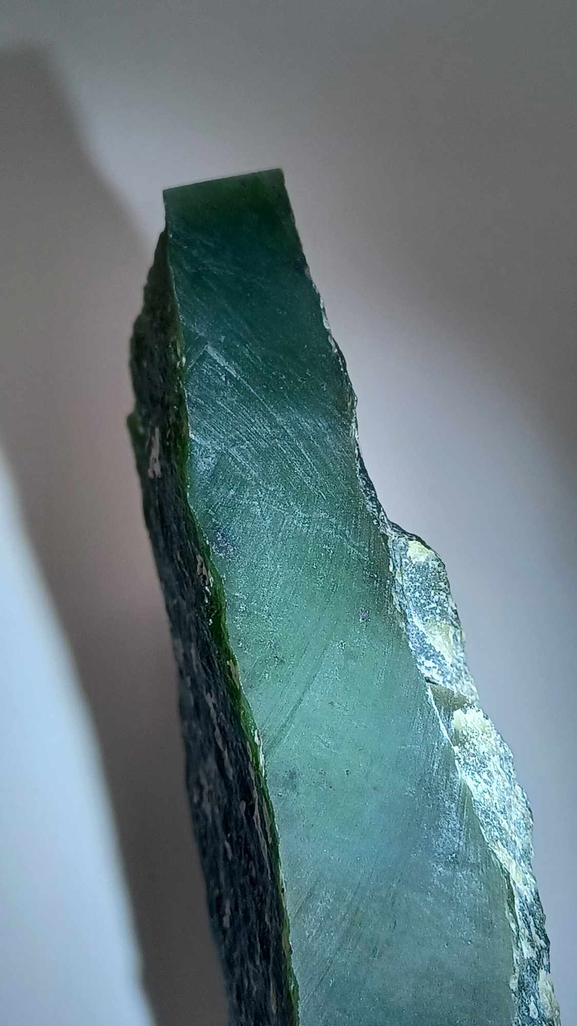 close up High-resolution image of a Cassiar Nephrite Jade Slab High Translucency 547g showcasing its luminous, translucent green jade with intricate Colors of Light Transparent Green